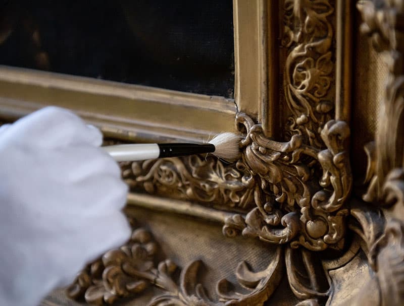 Specialist frame cleaning with gloved had and brush