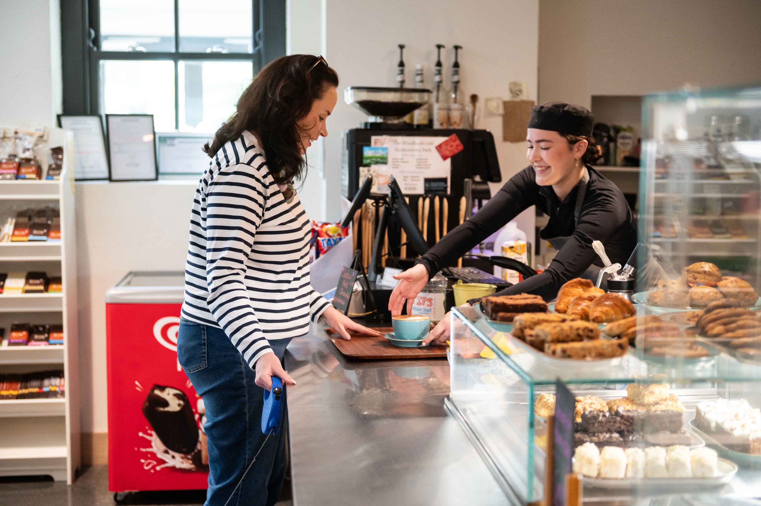 A woman is served a coffee at the cafe at Strokestown Park