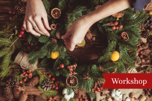 Hands decorating Christmas Wreath
