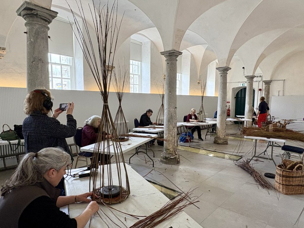 Participants taking part in the Willow Weaving Workshop in the Vaulted Stables at Strokestown Park.