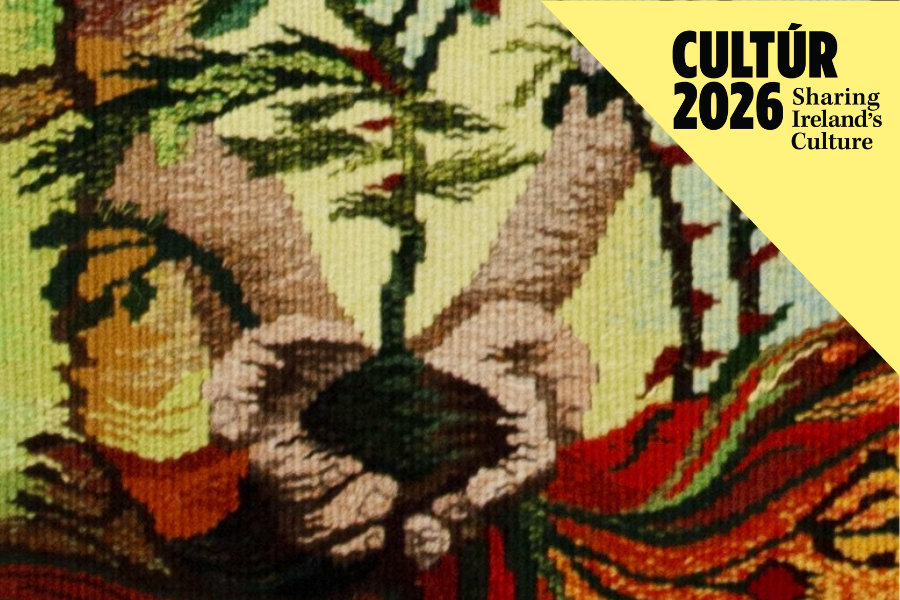 Woven Tapestry of hands holding soil with a plant growing from it with Culture 2026 Sharing Ireland's Culture wrote in the top right corner