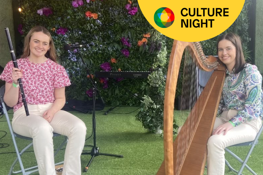 Emily Keane holding her flute and Emma Benson with Harp.