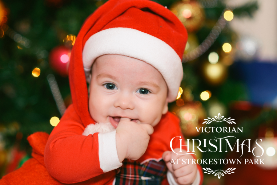 Smiling baby in a Santa outfit