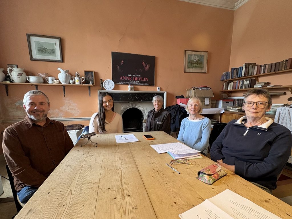 John O Driscoll, manager of Strokestown Park, Tara Brady of MacConmara Consulting, Dr. Tara Carroll, Volunteer Co-ordinator at Strokestown Park, Irish Heritage Trust Volunteers Cáit Browne and Mary Geoghan sitting around wooden table in Catherine's Kitchen, Strokestown Park House